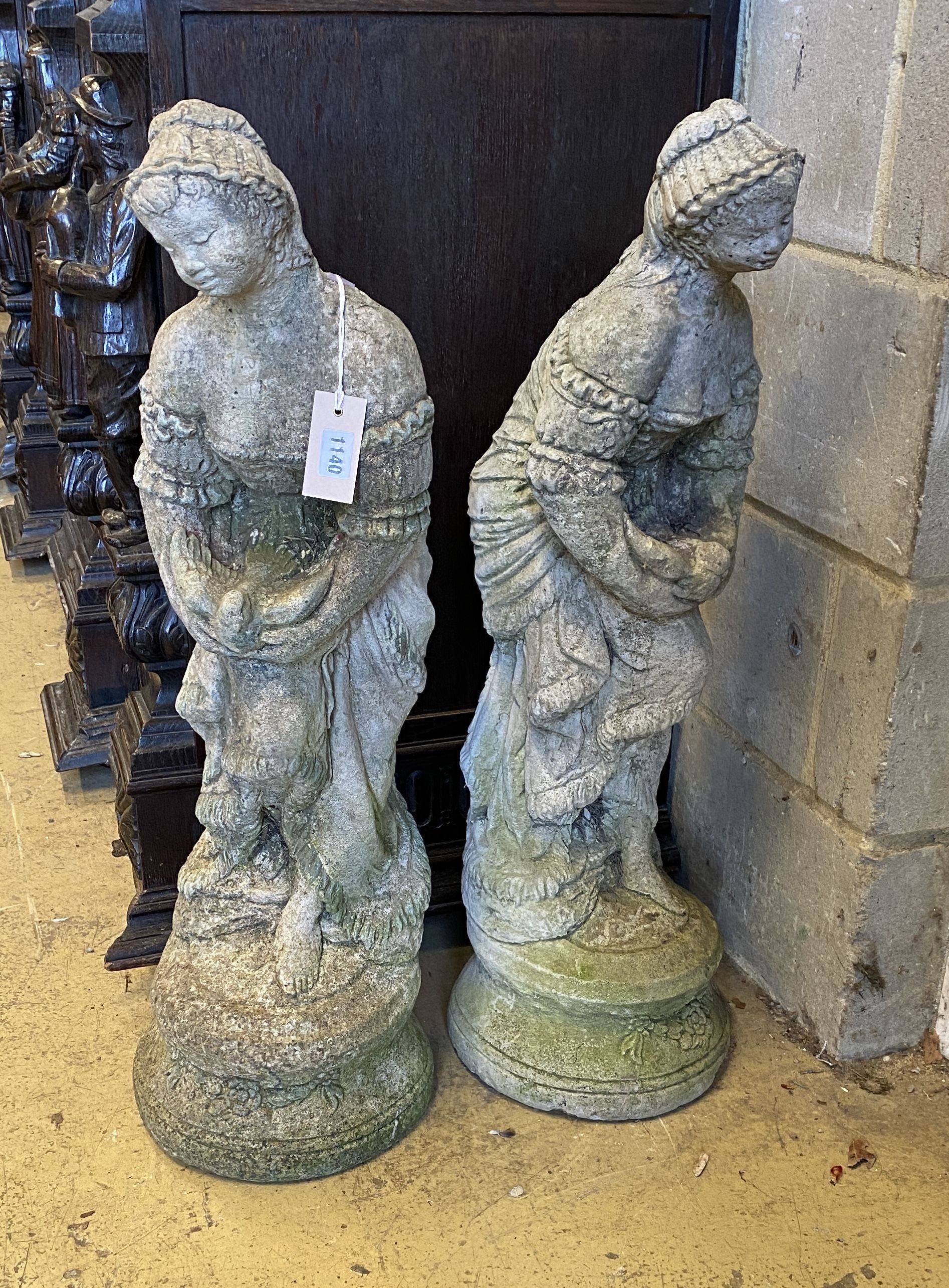 A pair of reconstituted stone garden ornaments, height 82cm